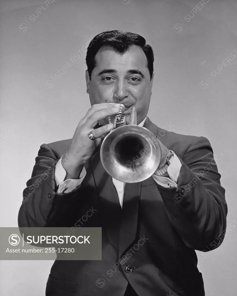 Portrait of a mid adult man playing the trumpet
