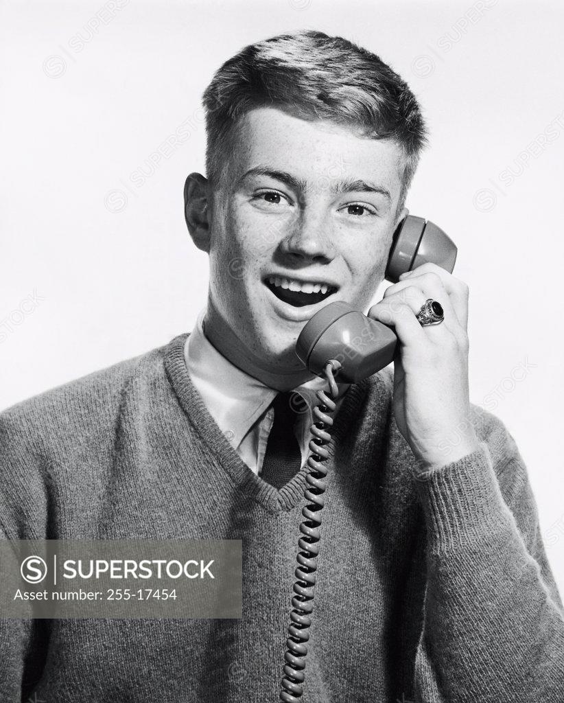 Stock Photo: 255-17454 Portrait of a teenage boy talking on the phone, 1965