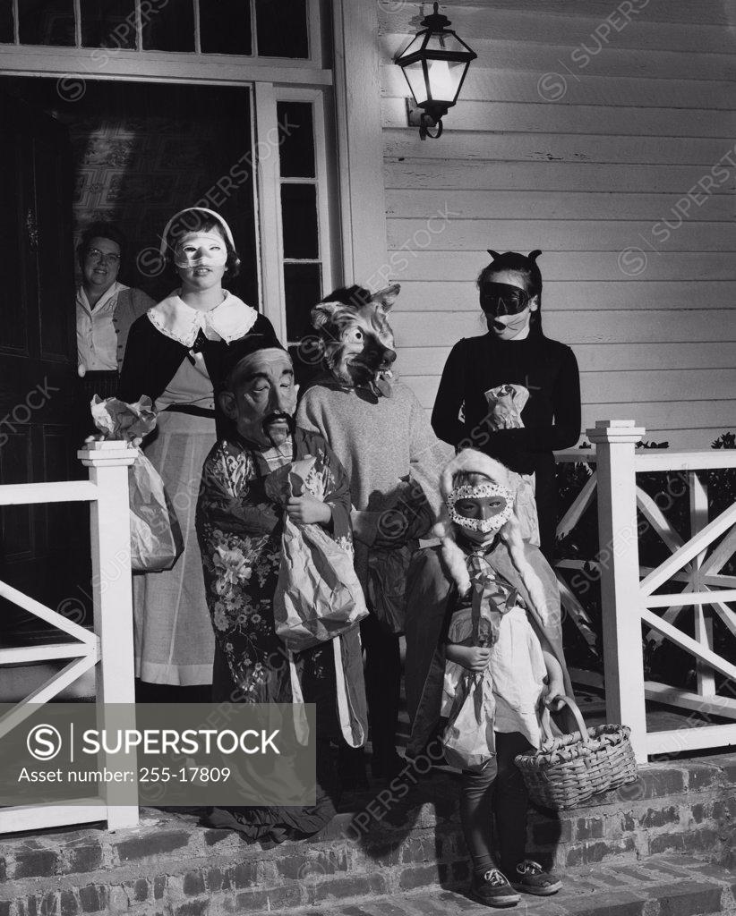 Stock Photo: 255-17809 Five children wearing Halloween costumes for trick or treating
