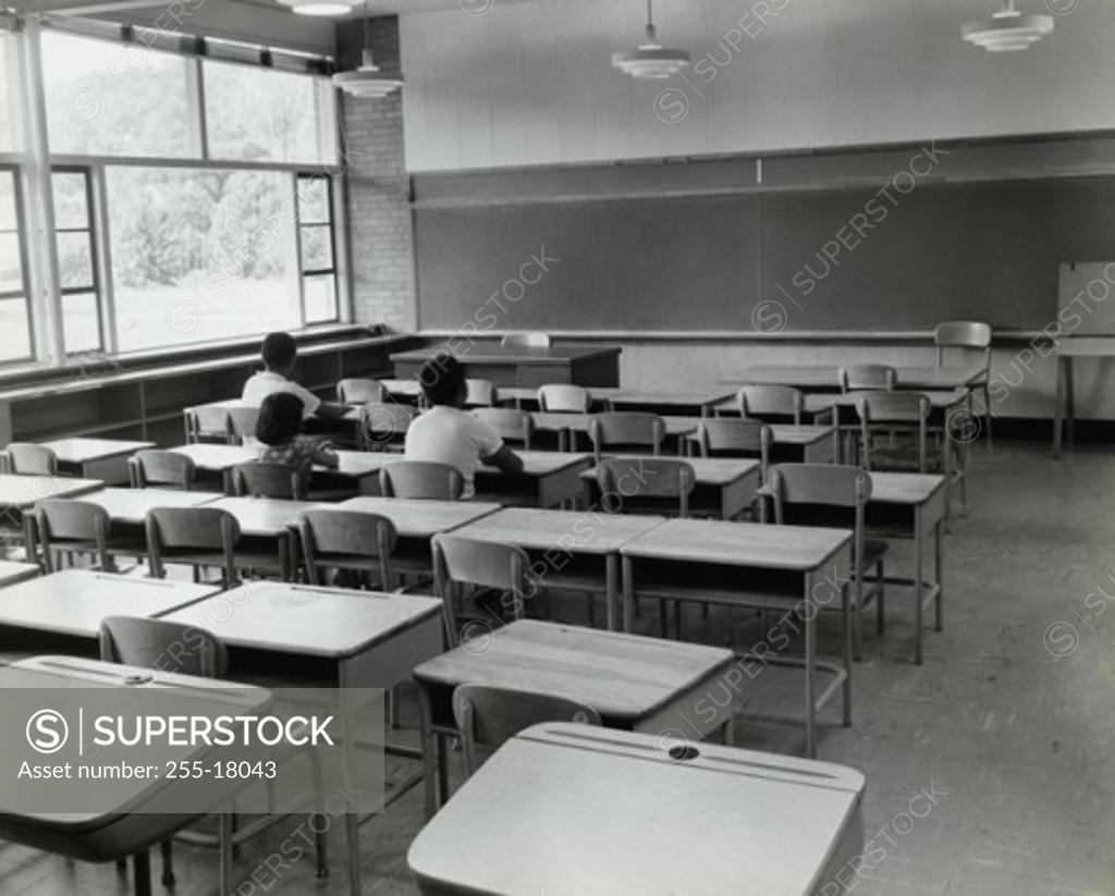 Stock Photo: 255-18043 Rear view of three students sitting in a classroom