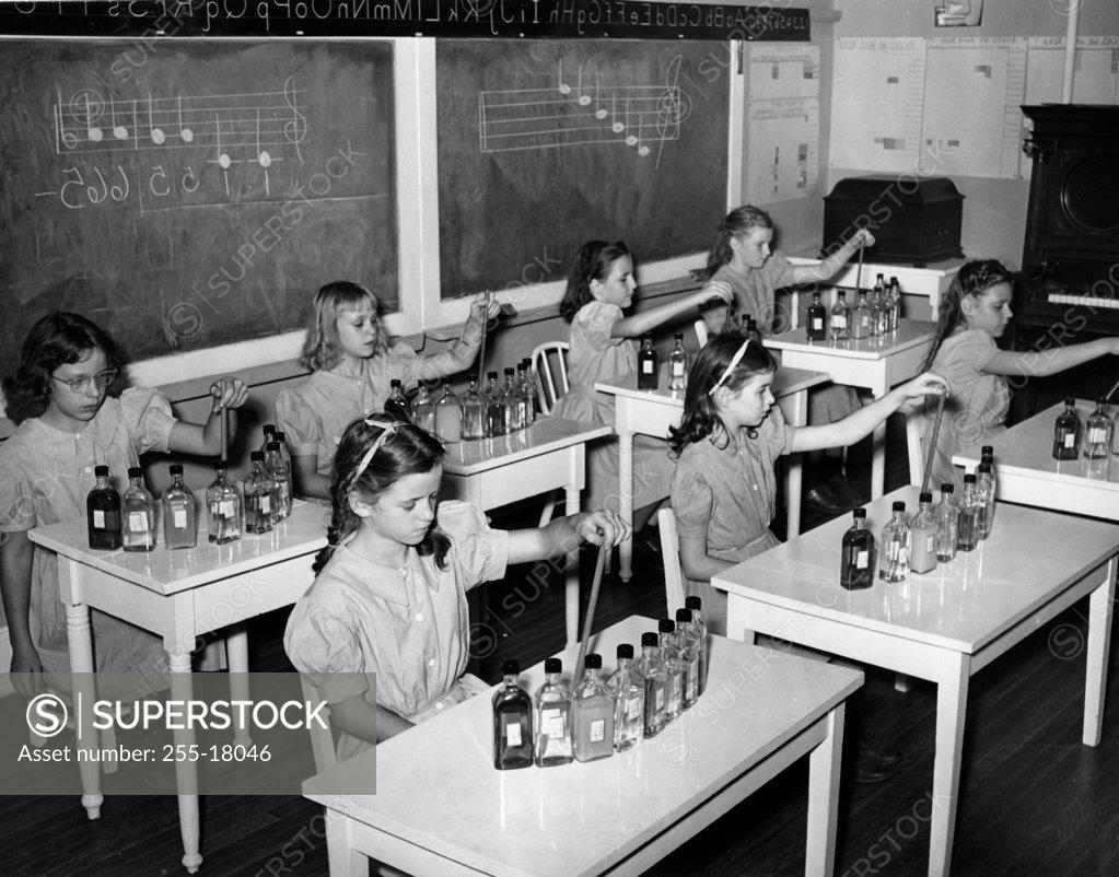 Stock Photo: 255-18046 Group of school girls sitting in a music class