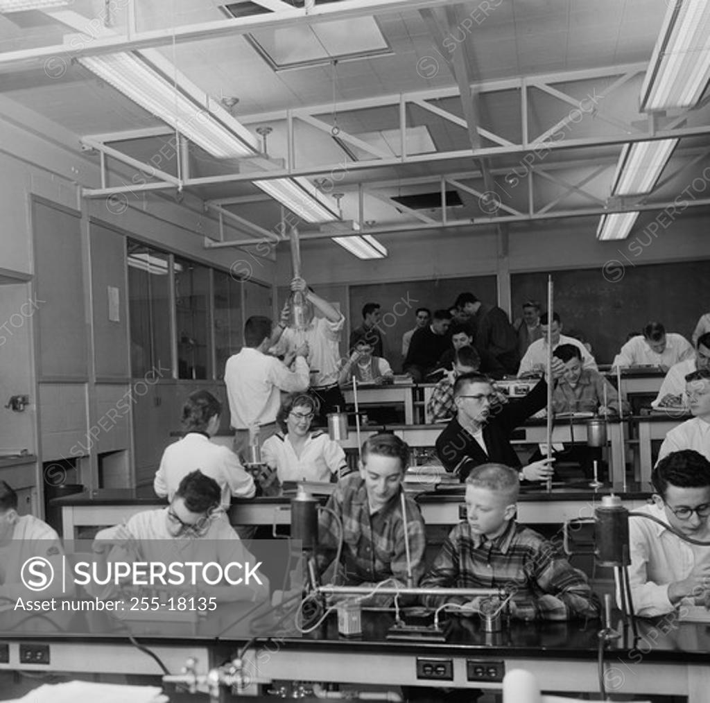 Stock Photo: 255-18135 Students performing experiments in a chemistry laboratory