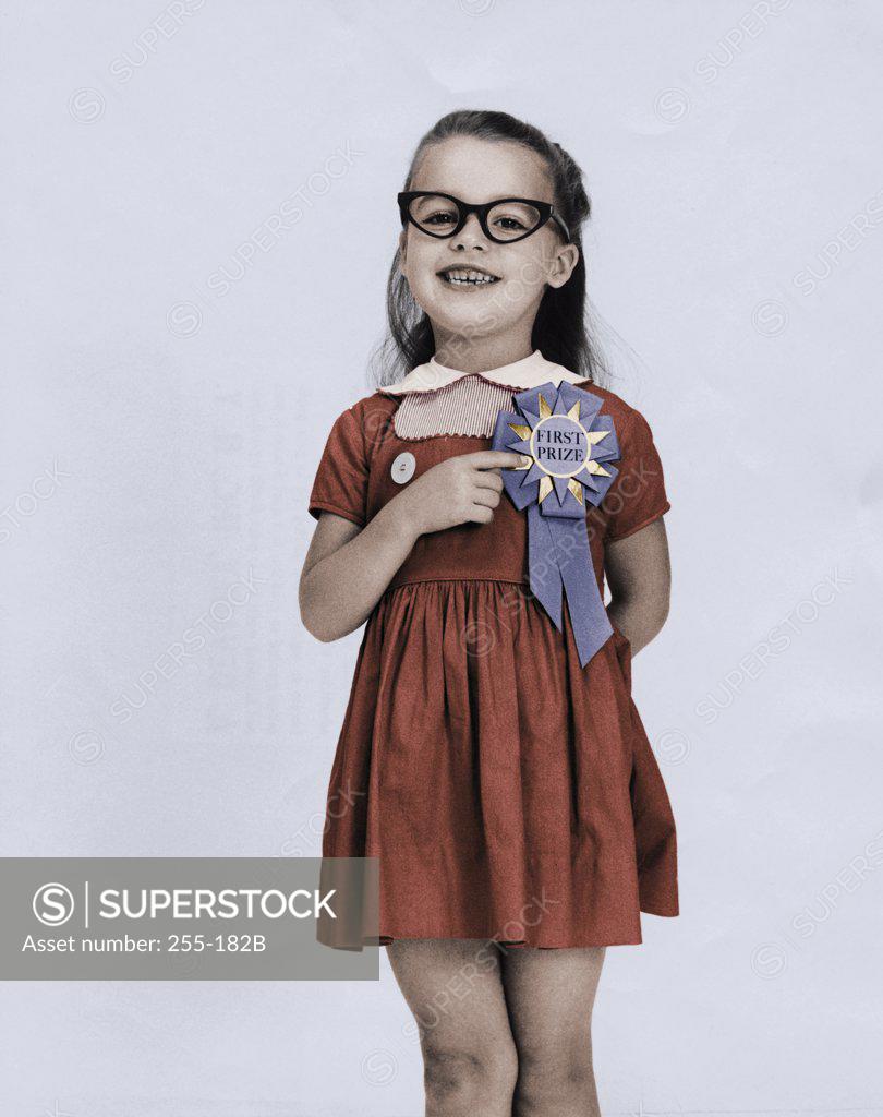 Stock Photo: 255-182B Portrait of a girl pointing to her first place ribbon