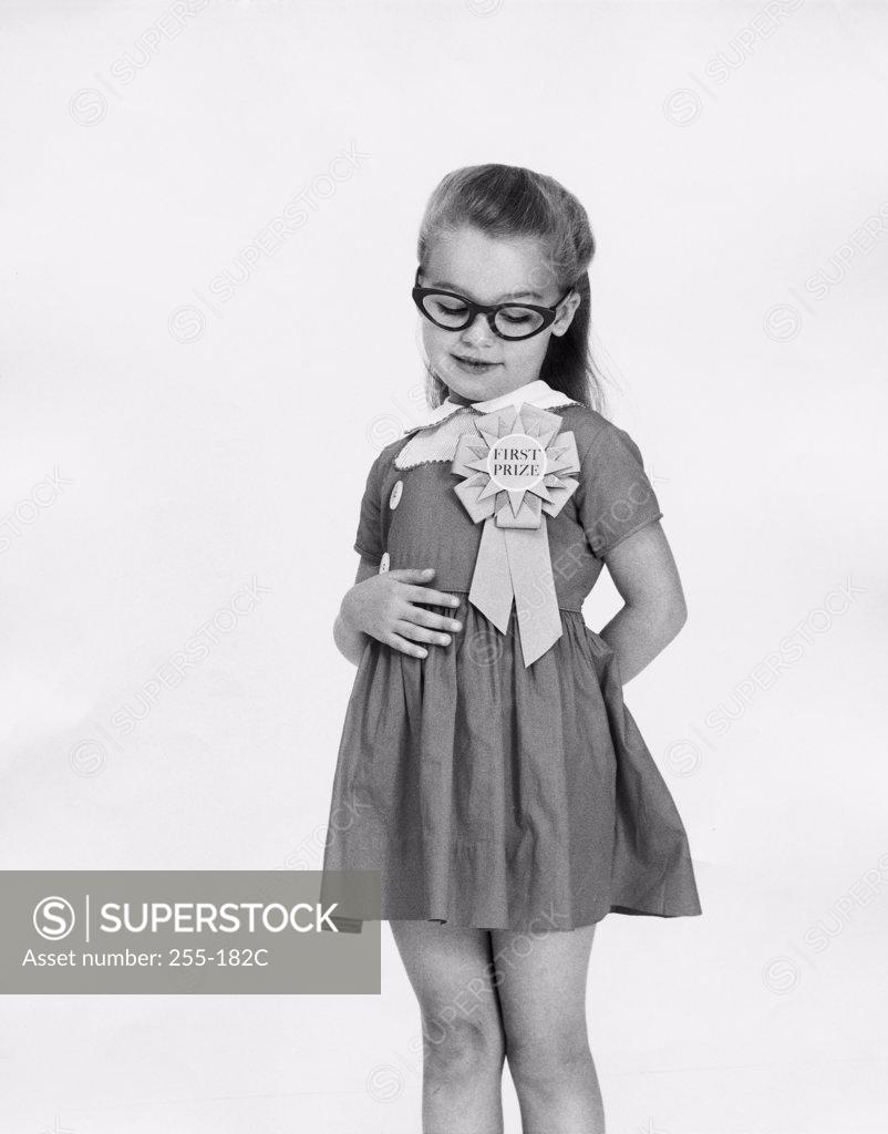 Stock Photo: 255-182C Girl looking at her first place ribbon