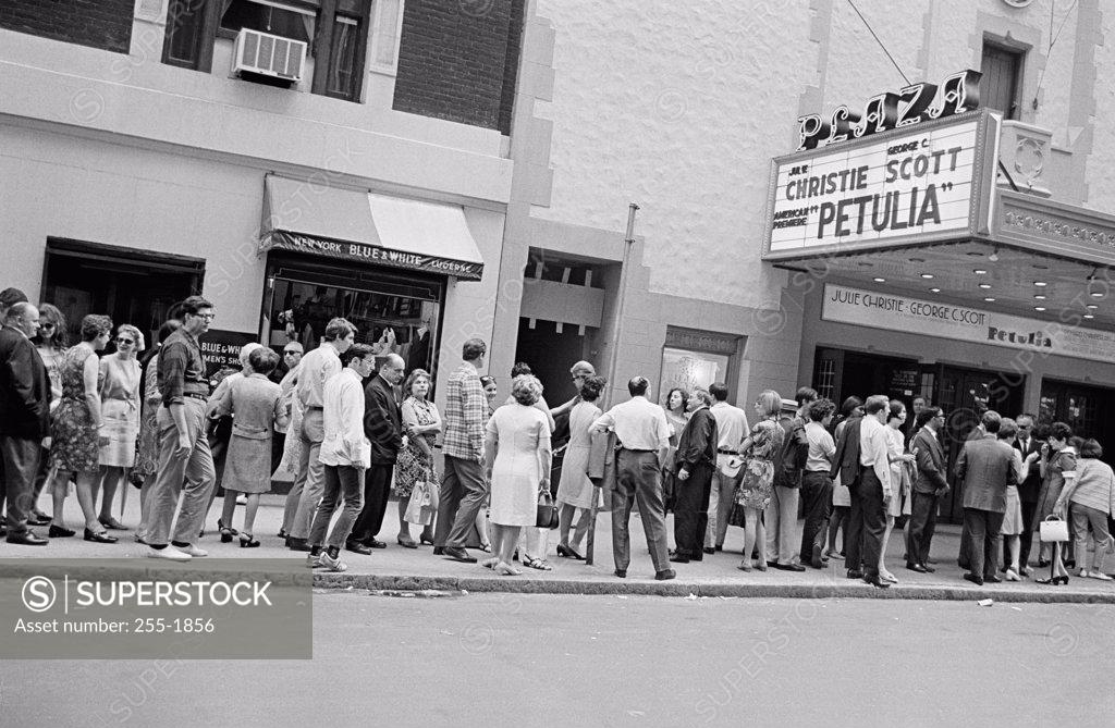 Stock Photo: 255-1856 Group of people standing in front of a movie theater
