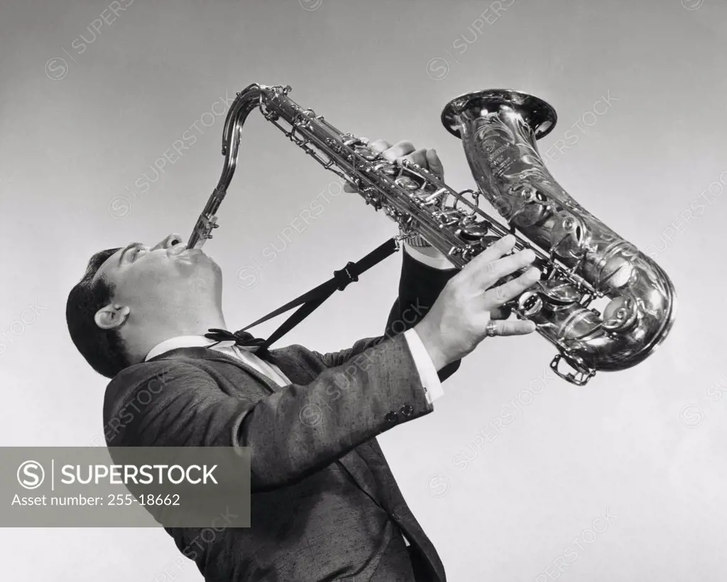 Mid adult man playing the saxophone