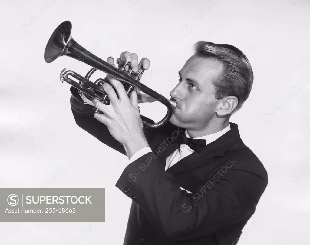Close-up of a mid adult man playing a trumpet