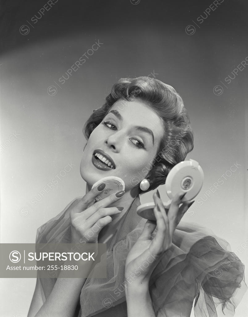 Stock Photo: 255-18830 Close-up of a young woman applying face powder