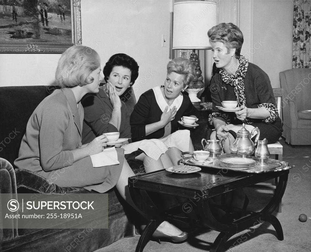 Stock Photo: 255-18951A Four young women sitting together drinking tea