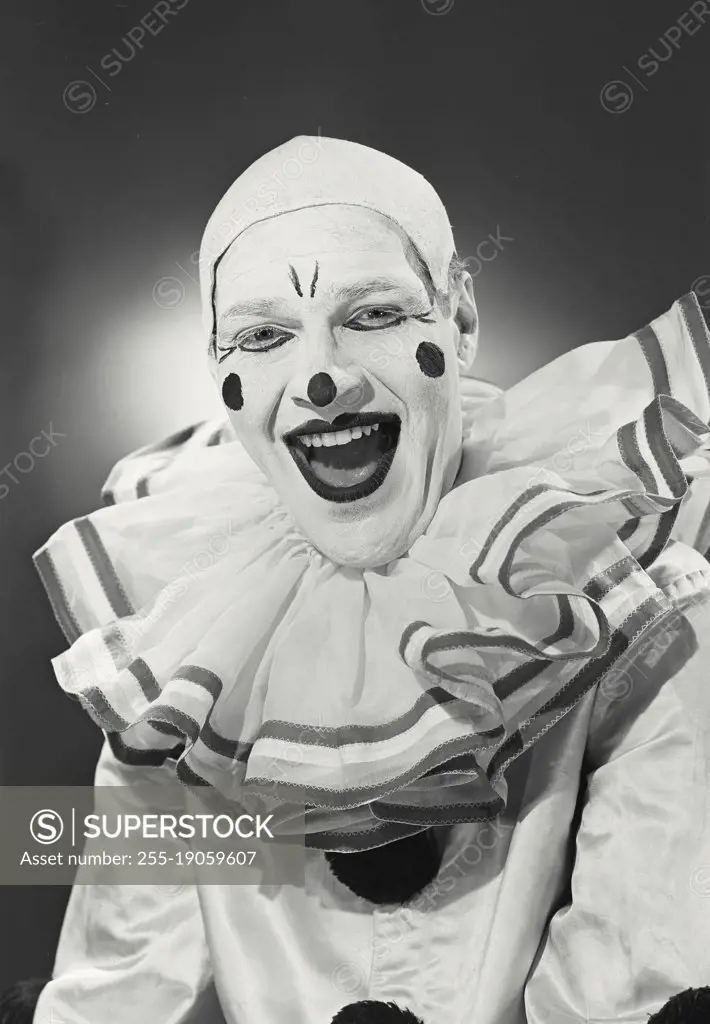 Vintage photograph. Portrait of clown in collar smiling.