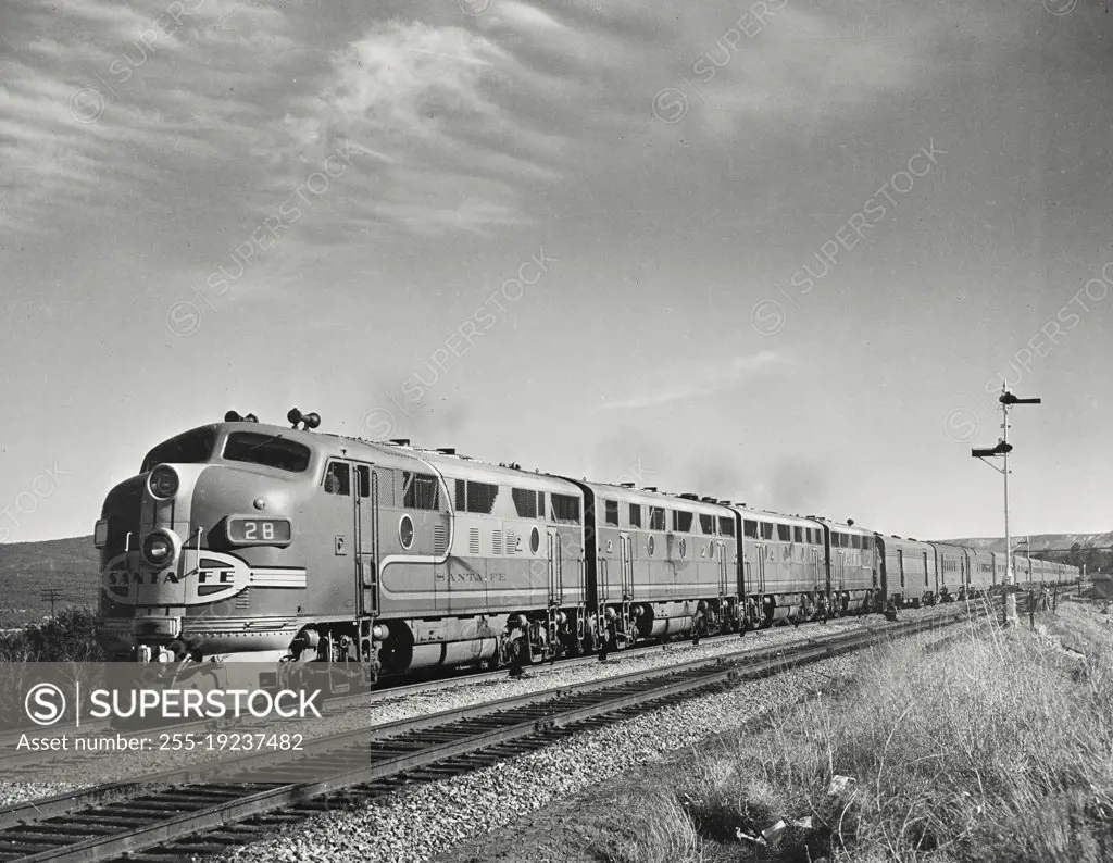 Vintage photograph. Santa Fe Chief #19 powered by General Motors diesel electric engine speeds westward near Fox, New Mexico
