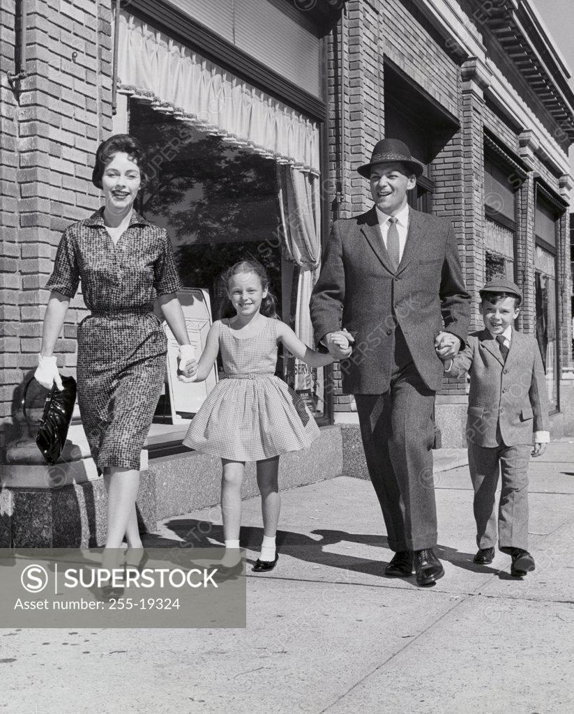 Stock Photo: 255-19324 Family walking on the sidewalk