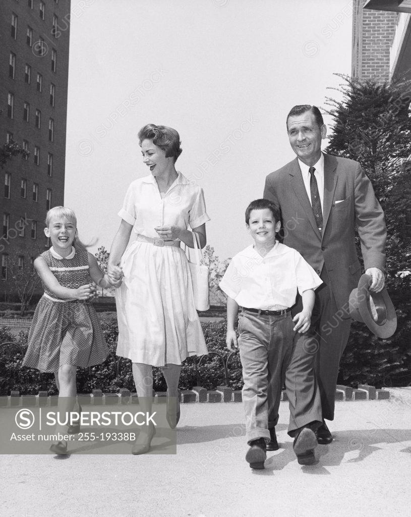 Stock Photo: 255-19338B Mature couple walking with their son and daughter