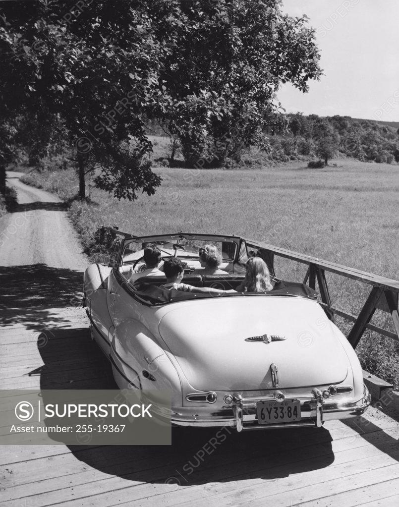 Stock Photo: 255-19367 Family traveling in convertible car