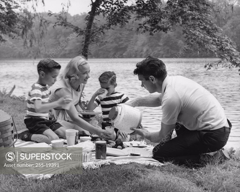 Stock Photo: 255-19391 Family with two sons having picnic at lakeshore