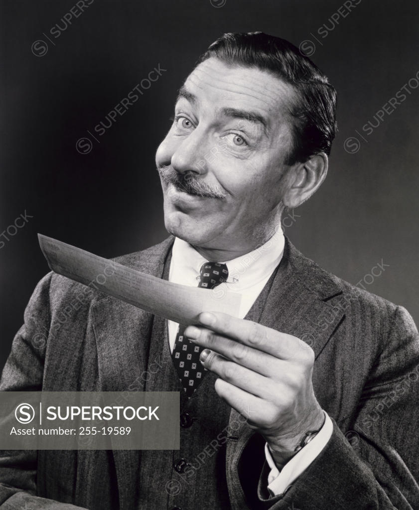 Stock Photo: 255-19589 Portrait of a businessman holding a check