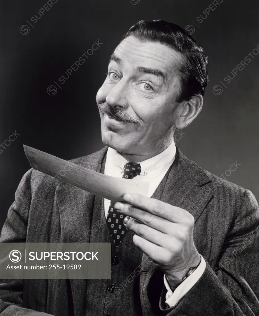 Portrait of a businessman holding a check