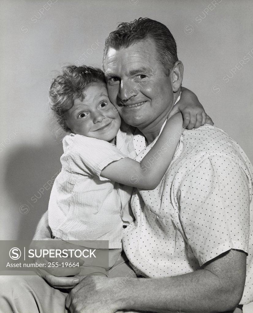 Stock Photo: 255-19664 Portrait of a daughter hugging her father