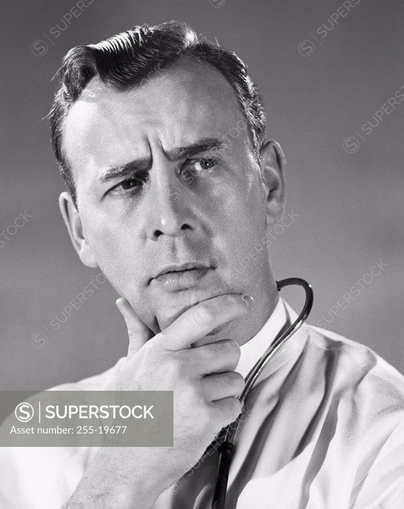 Stock Photo: 255-19677 Close-up of a male doctor with his hand on his chin