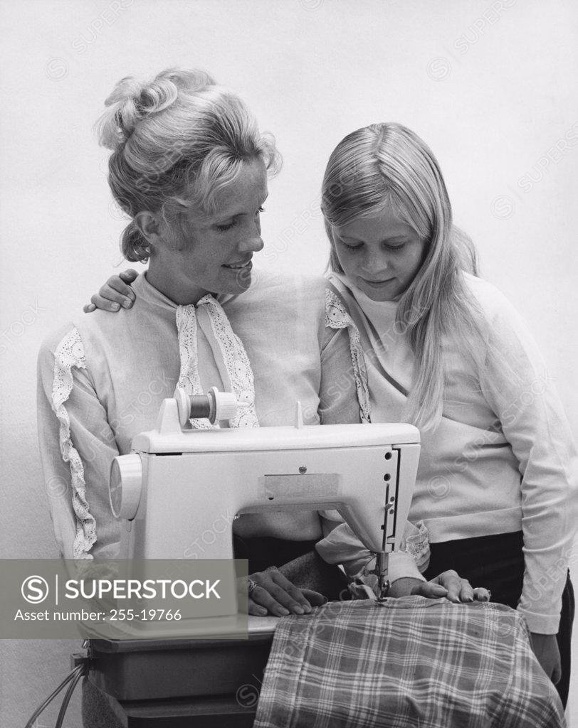 Stock Photo: 255-19766 Mother sewing with her daughter