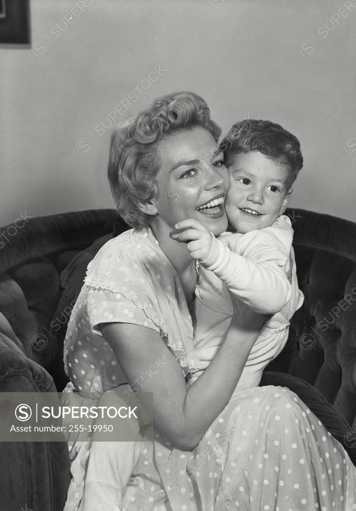 Stock Photo: 255-19950 Close-up of a mid adult woman holding her son and smiling