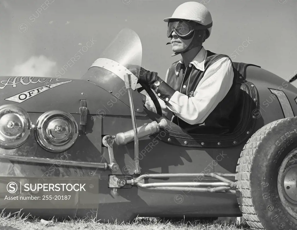 Vintage photograph. Mid adult man wearing race goggles driving Allen Offy - Special midget auto racer