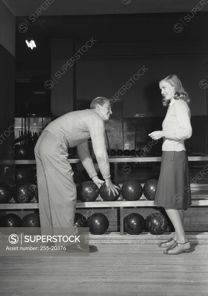 Stock Photo: 255-20376 Side profile of a young couple at a bowling alley