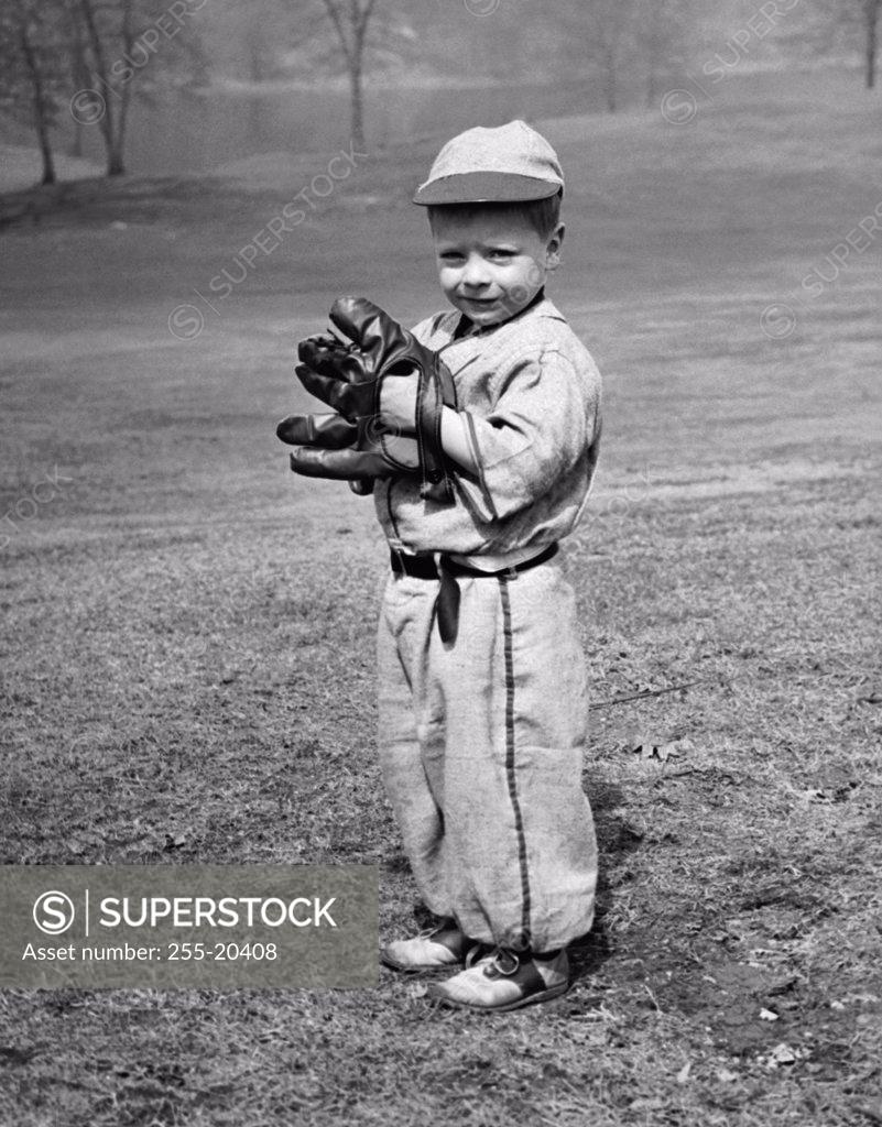 Stock Photo: 255-20408 Youth league baseball player standing on a baseball field