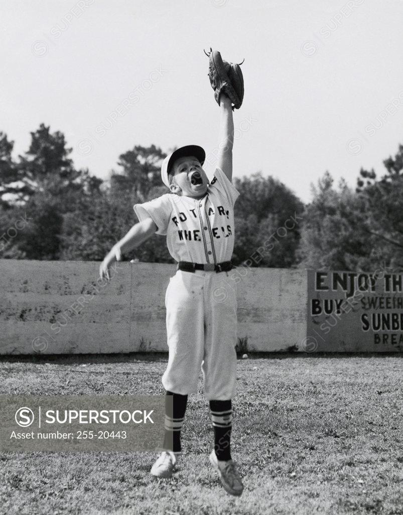 Stock Photo: 255-20443 Baseball player jumping in a baseball field