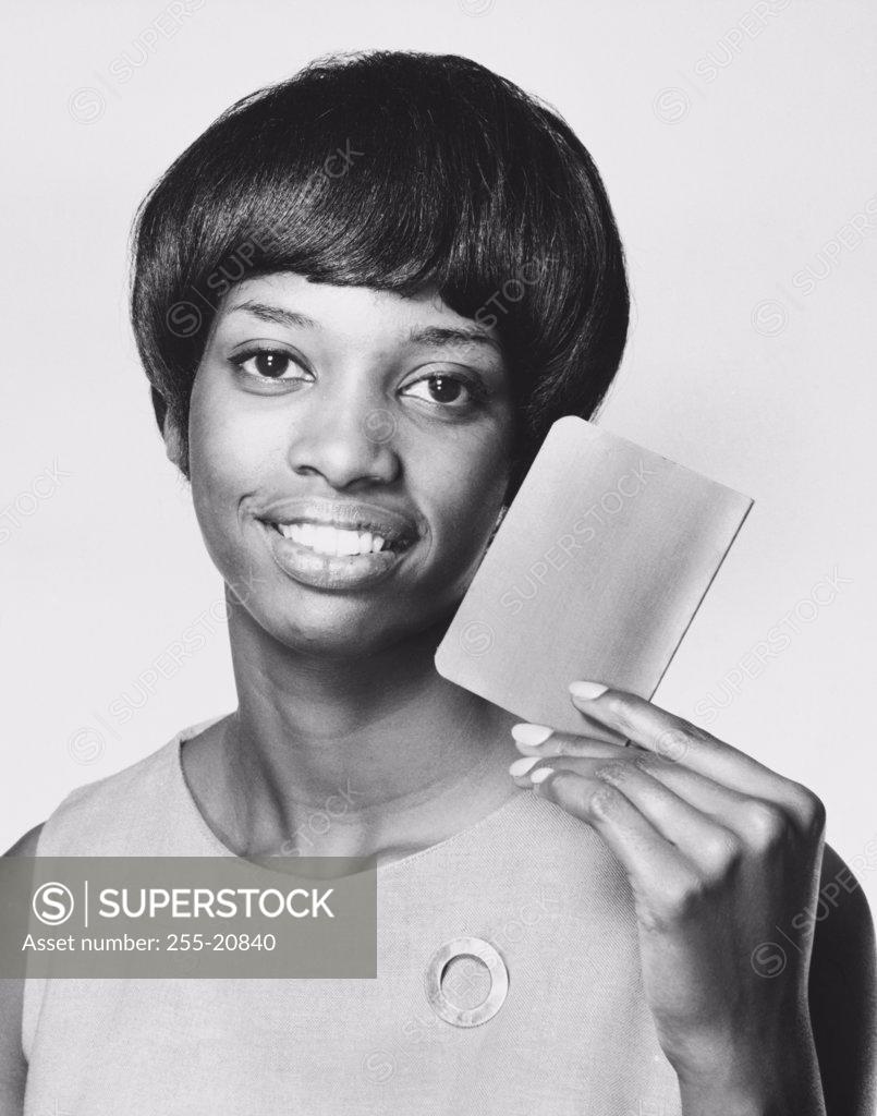 Stock Photo: 255-20840 Portrait of a young woman showing a bank book