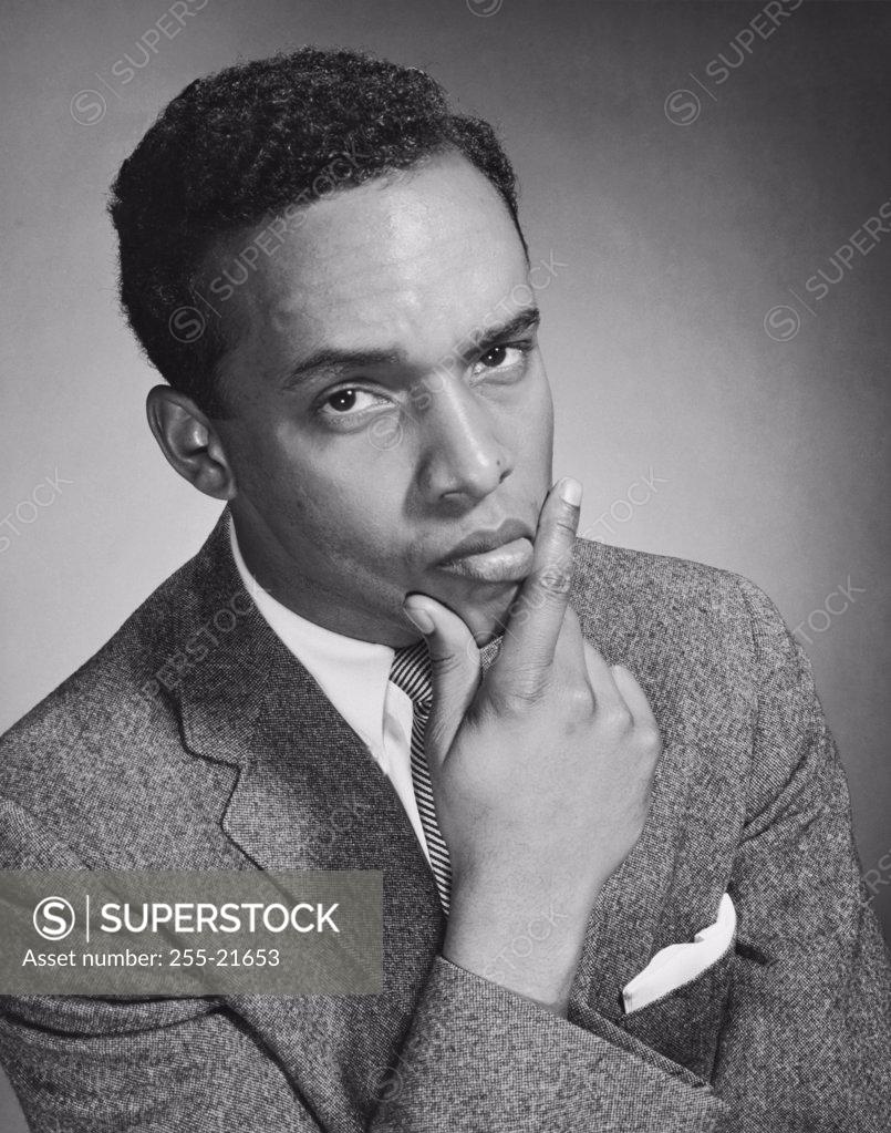 Stock Photo: 255-21653 Portrait of a businessman thinking with his hand on his chin