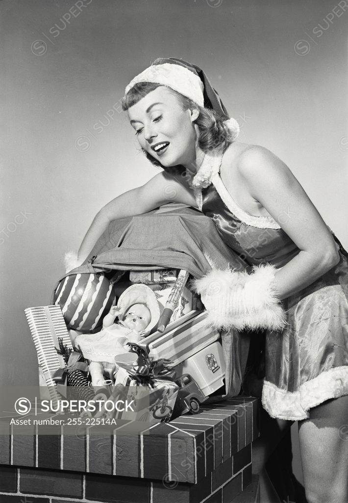 Stock Photo: 255-22514A Close-up of a young woman holding a sack of Christmas presents