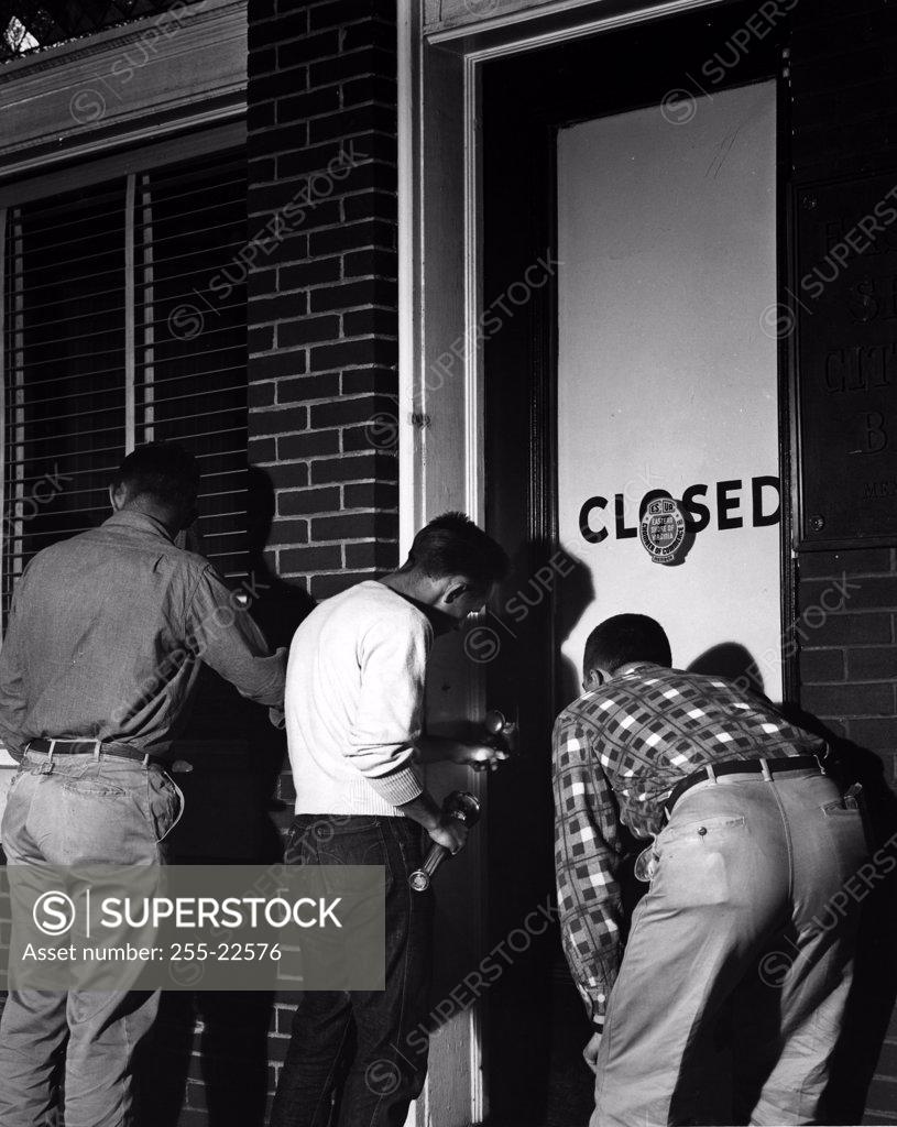 Stock Photo: 255-22576 Three men breaking in to office