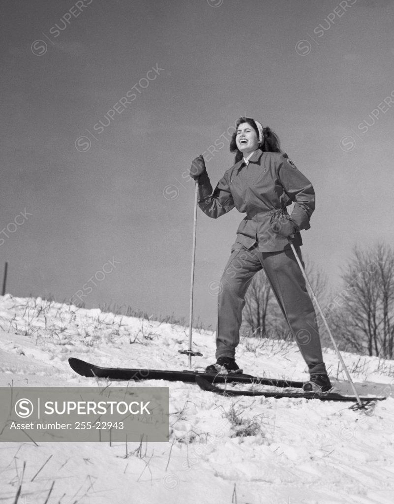 Stock Photo: 255-22943 Low angle view of a young woman skiing on snow