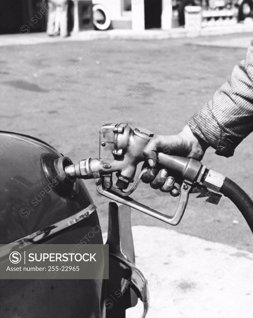 Stock Photo: 255-22965 Gas station attendant filling up a car
