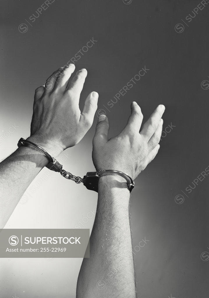 Stock Photo: 255-22969 Close-up of man's hand wearing handcuffs