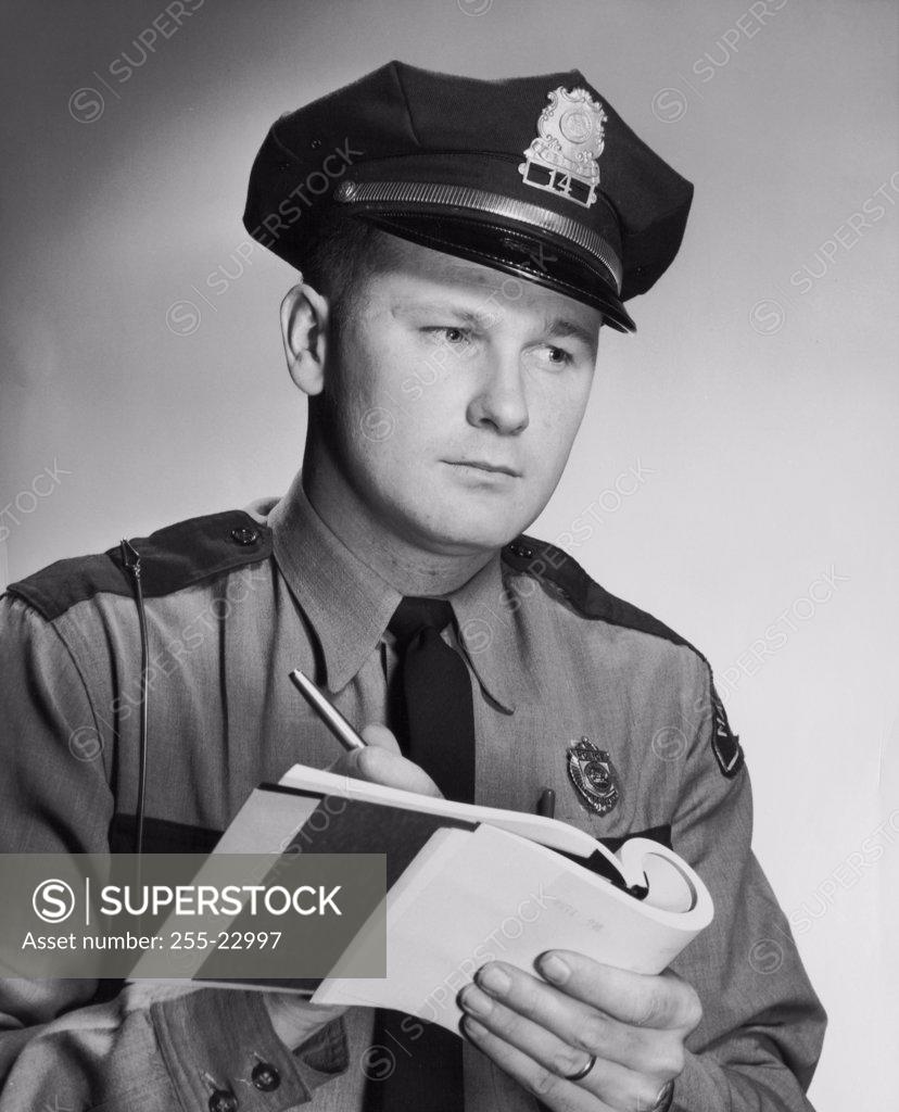 Stock Photo: 255-22997 Close-up of a policeman writing on a note pad