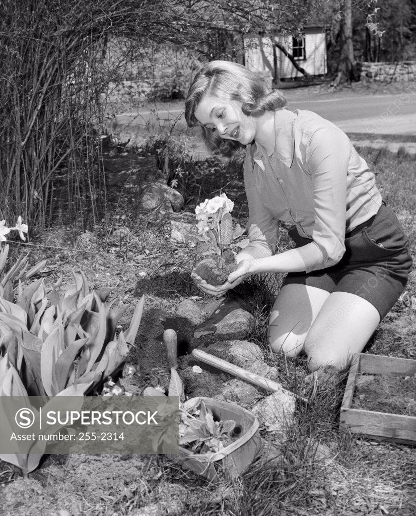 Stock Photo: 255-2314 Young woman gardening