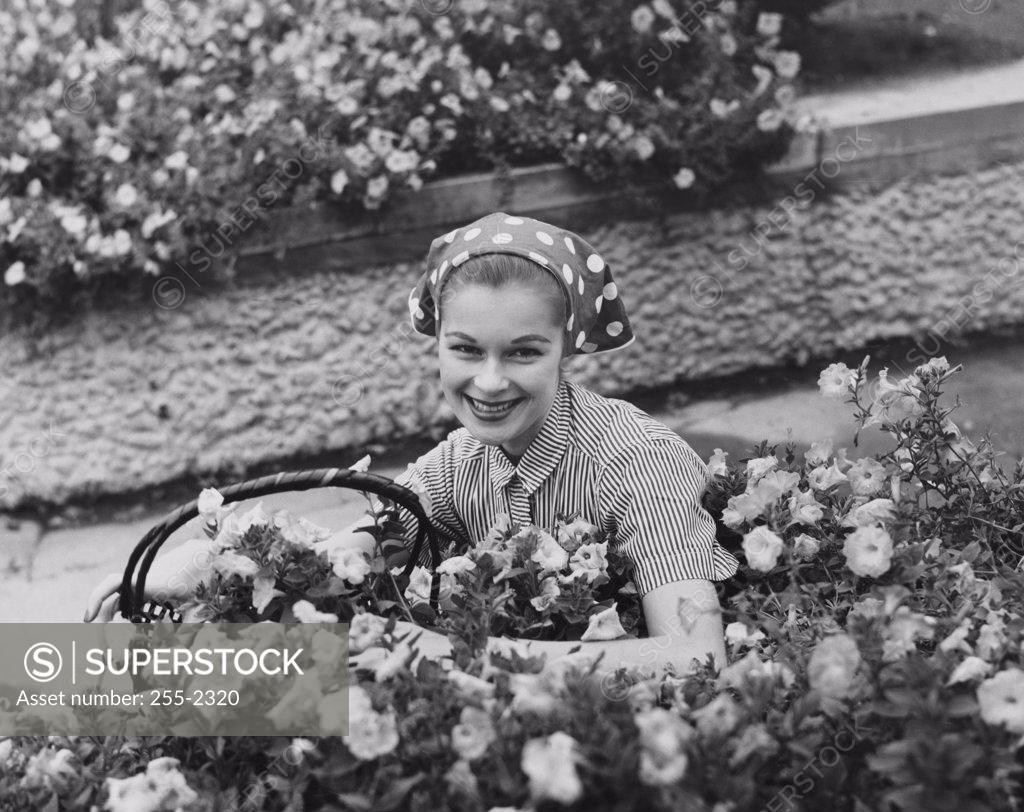 Stock Photo: 255-2320 Young woman gardening