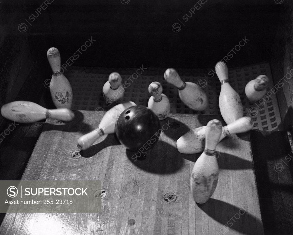 Stock Photo: 255-23716 High angle view of bowling ball knocking down bowling pins,