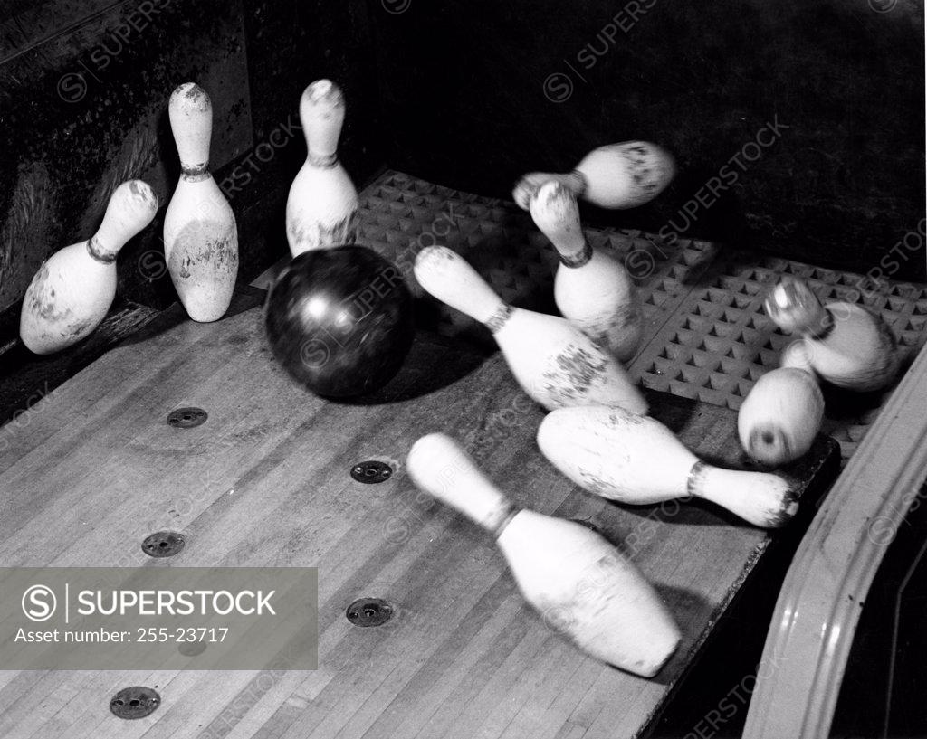 Stock Photo: 255-23717 High angle view of a bowling ball knocking down bowling pins