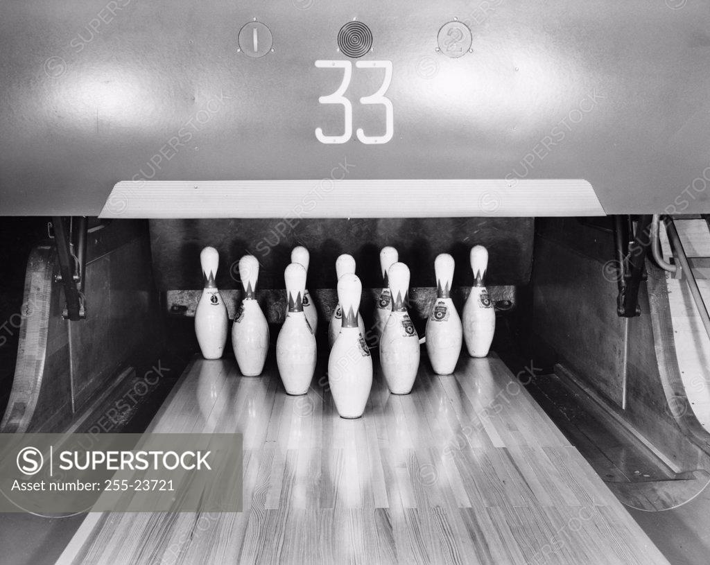 Stock Photo: 255-23721 Bowling pins set up at the end of a lane