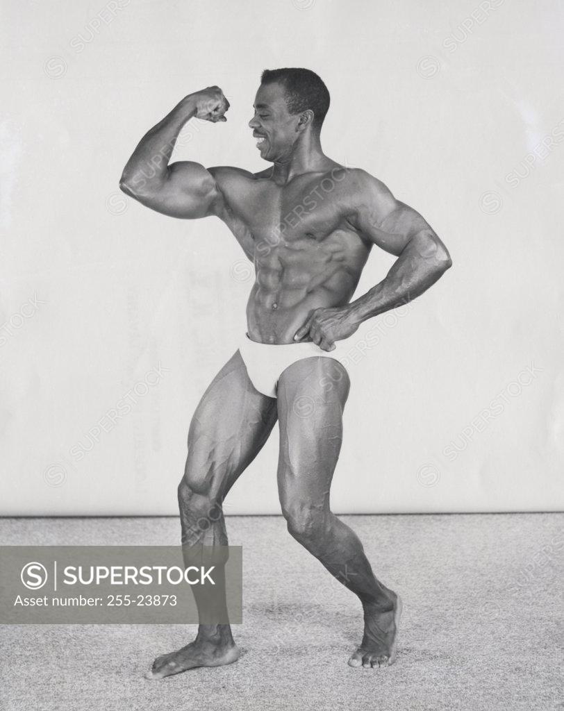 Stock Photo: 255-23873 Male body builder flexing his muscles