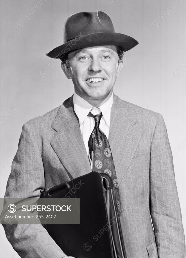 Stock Photo: 255-2407 Portrait of a businessman holding a briefcase