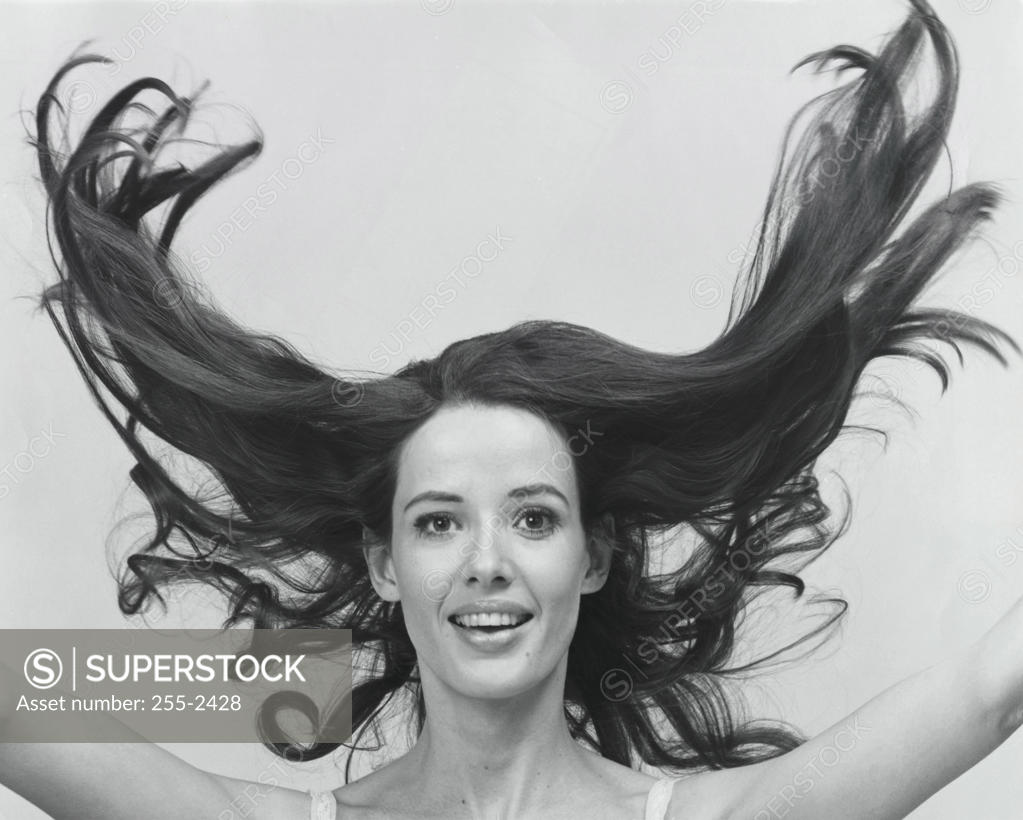 Stock Photo: 255-2428 Portrait of a young woman with her hair flying