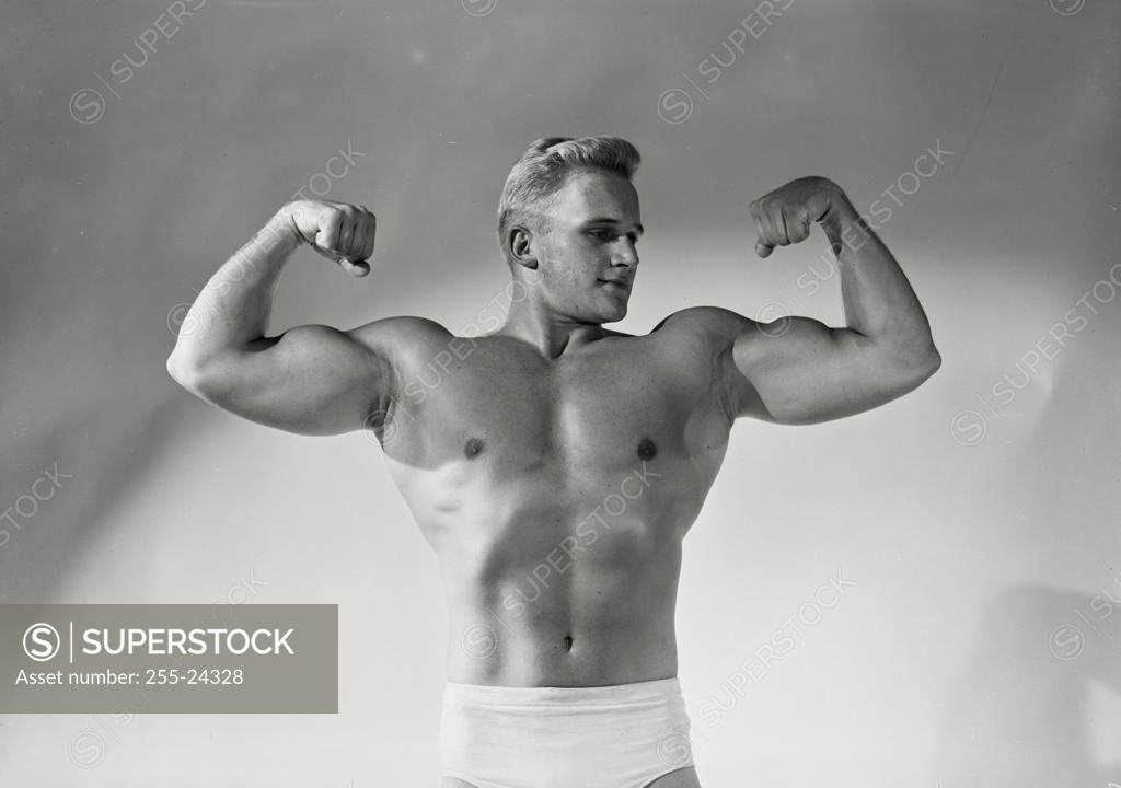 Stock Photo: 255-24328 Close-up of a young man flexing his muscles