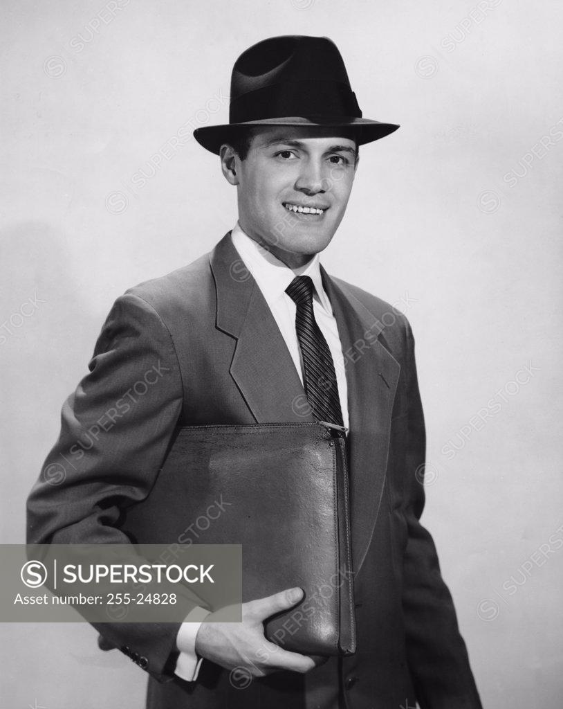 Stock Photo: 255-24828 Portrait of a businessman holding a file