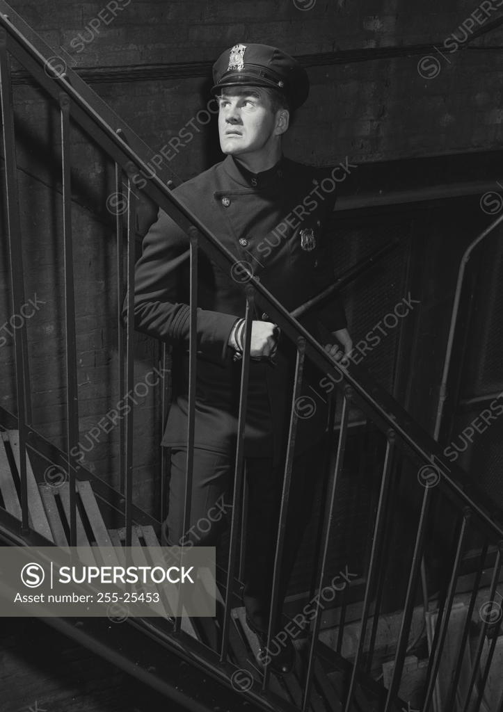 Stock Photo: 255-25453 Policeman standing near a staircase
