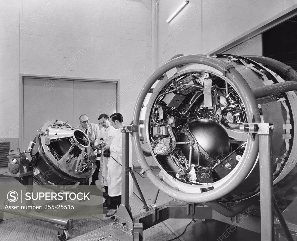 Stock Photo: 255-25515 Three scientists working on satellites in a laboratory, GE Space Technology Labs, Valley Forge, Pennsylvania, USA
