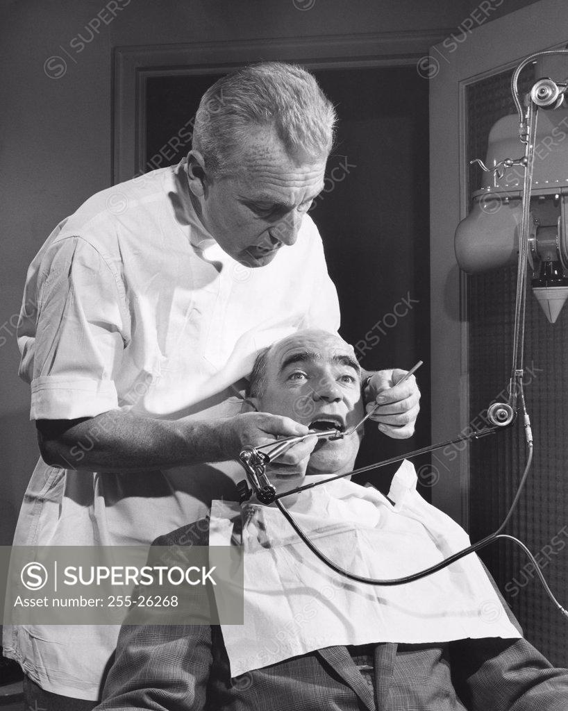 Stock Photo: 255-26268 Mature man getting a treatment from a dentist